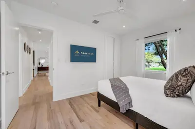 a white bedroom with a bed and a window at Samadhi - NEW 15 min drive to Ultra, by Newman Hospitality in Miami Shores