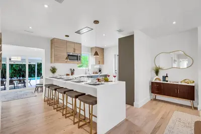 a kitchen with a white counter and bar stools at Samadhi - NEW 15 min drive to Ultra, by Newman Hospitality in Miami Shores