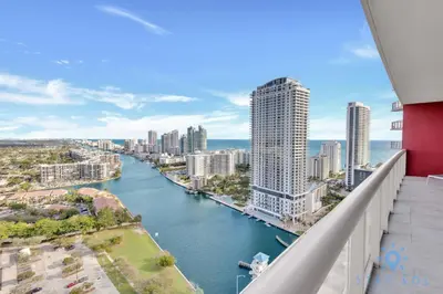 arial view of a river in a city with tall buildings at Breathtaking 31st Fl Beachwalk Penthouse View in Hallandale Beach