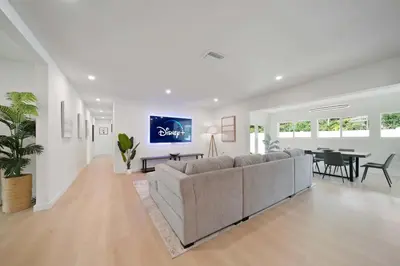 a living room with a couch and a dining room at New Luxury Villa Delilah Biscayne Park in Biscayne Park