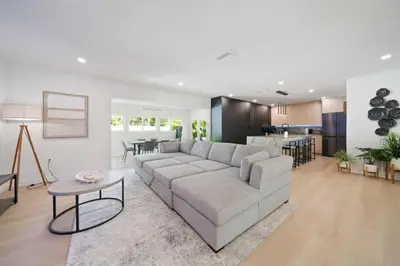 a living room with a couch and a table at New Luxury Villa Delilah Biscayne Park in Biscayne Park