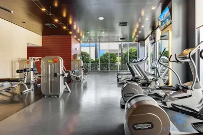 a gym with several treadmills and machines at Spectacular Balcony View Retreat Resort Amenities in Hallandale Beach