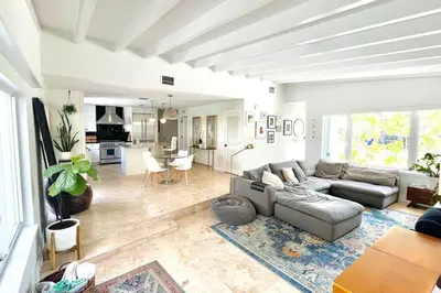 a living room with a couch and a kitchen at Pool! Best location! Steps to the water! Kid friendly! in Miami
