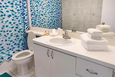 a bathroom with a sink and a toilet and a shower at Miami Beach Apartments by MiaRentals in Miami Beach