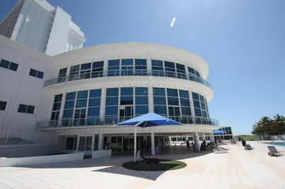 a large building with an umbrella in front of it at Miami Beach Apartments by MiaRentals in Miami Beach