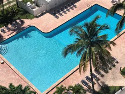 an overhead view of a swimming pool with palm trees at Oceanfront Miami Beach Studio 925 in Miami Beach