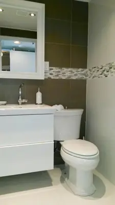 a bathroom with a white toilet and a sink at Oceanfront Miami Beach Studio 925 in Miami Beach