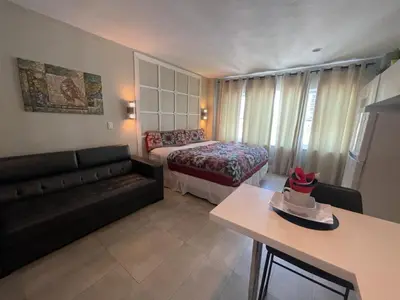 a living room with a couch and a bed at Oceanfront Miami Beach Studio 925 in Miami Beach
