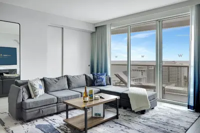 a living room with a couch and a table at Nautica - Ocean View & Rooftop Pools! by Newman Hospitality in Fort Lauderdale
