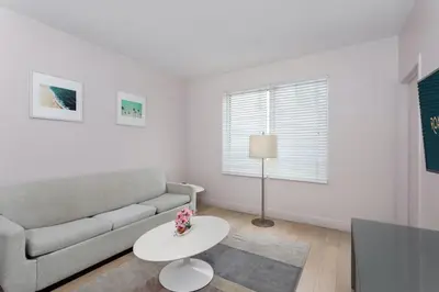 a living room with a couch and a table at Roami at Hotel Astor in Miami Beach