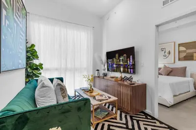 a living room with a couch and a bed at Miami Magic Vibrant 2 Bedroom with Free Parking in Miami