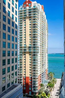 a view of a tall building next to the ocean at Amazing 1 Bed in Brickell key With FREE PKG in Miami