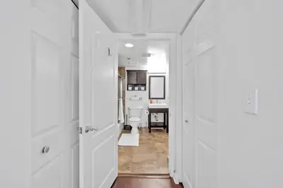 a hallway with white doors and a bathroom with a toilet at Amazing 1 Bed in Brickell key With FREE PKG in Miami