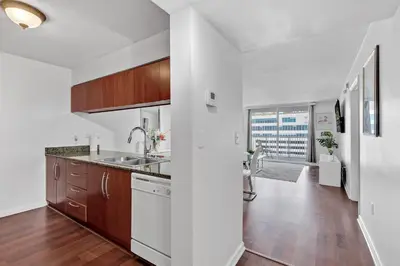 a kitchen with a sink and wooden cabinets at Amazing 1 Bed in Brickell key With FREE PKG in Miami
