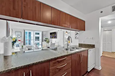a kitchen with a sink and a living room at Amazing 1 Bed in Brickell key With FREE PKG in Miami