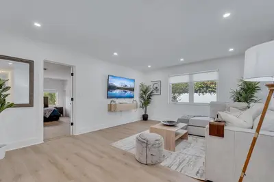 a white living room with a couch and a table at Gated Villa Blanca 5BR 3BA with Heated Pool & BBQ in Miami