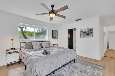 a bedroom with a bed and a ceiling fan at Gated Villa Blanca 5BR 3BA with Heated Pool & BBQ in Miami