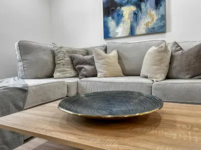 a living room with a couch and a plate on a coffee table at Gated Villa Blanca 5BR 3BA with Heated Pool & BBQ in Miami
