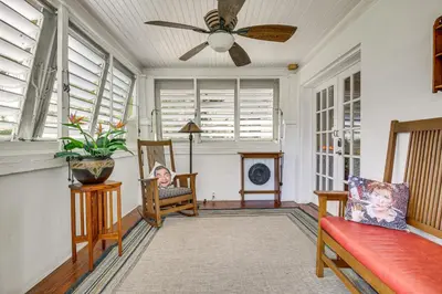a living room with a ceiling fan and chairs at Fort Lauderdale Oasis with Pool about 2 Mi to Beach! in Fort Lauderdale