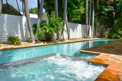 a swimming pool with a fountain in the middle at Fort Lauderdale Oasis with Pool about 2 Mi to Beach! in Fort Lauderdale