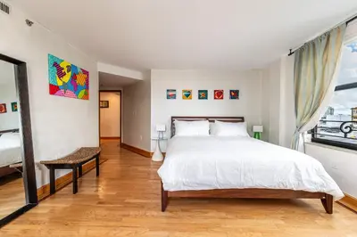 a bedroom with a large white bed and a window at The Netherland by MIAMI BEACH OCEAN RENTAL in Miami Beach
