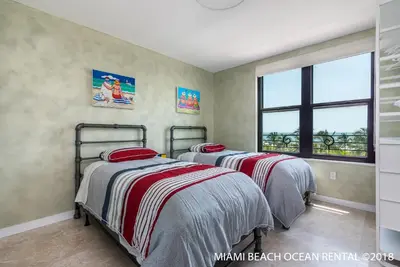 a bedroom with two beds and a window at The Netherland by MIAMI BEACH OCEAN RENTAL in Miami Beach