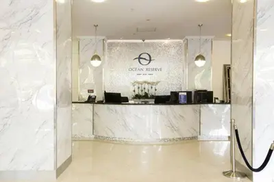 a lobby with a white marble counter in a building at Comfortable and broad apartment in O-Reserve near on the beach in Sunny Isles Beach