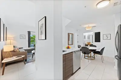 a kitchen and living room with a table and chairs at Modern apartment in Edgewater in Miami