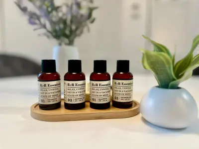 three bottles of ink sitting on a wooden tray next to a vase at Modern apartment in Edgewater in Miami