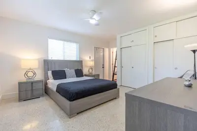 a bedroom with a bed and a dresser in it at Tropical Private Oasis Mins from Beach & Downtown in Miami