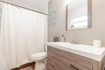 a bathroom with a sink and a toilet and a mirror at Tropical Private Oasis Mins from Beach & Downtown in Miami