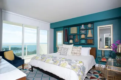 a bedroom with a bed and a blue wall at Coconut Grove 2 bedroom Apartment Amazing Views Includes Parking in Miami
