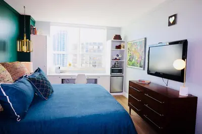 a bedroom with a blue bed and a flat screen tv at Coconut Grove 2 bedroom Apartment Amazing Views Includes Parking in Miami