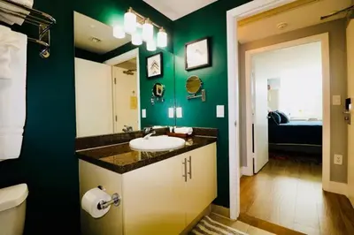 a bathroom with a sink and a green wall at Coconut Grove 2 bedroom Apartment Amazing Views Includes Parking in Miami