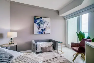 a bedroom with a bed and a chair and a window at Direct Bayview One Bedroom Condo in Coconut Grove Includes parking in Miami