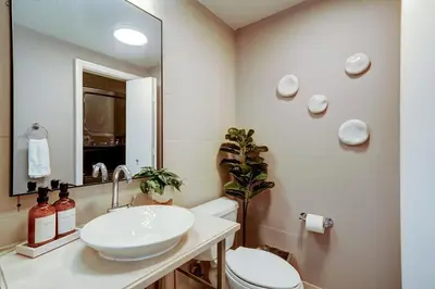 a bathroom with a sink and a toilet and a mirror at Direct Bayview One Bedroom Condo in Coconut Grove Includes parking in Miami