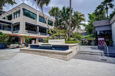 a building with a sign in front of it at Connecting Rooms-Coconut Grove 10th Floor- Parking Included in Miami