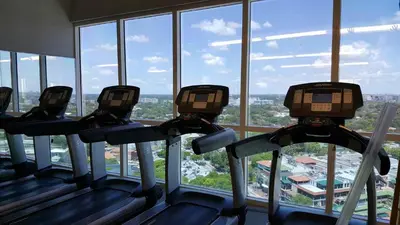 three treadmills in a gym looking out the window at Adorable 12th Floor Standard Unit Parking Included in Miami