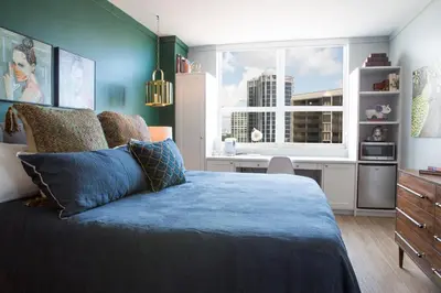 a bedroom with a blue bed and a window at Adorable 12th Floor Standard Unit Parking Included in Miami