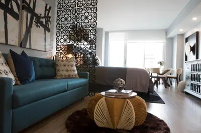 a living room with a blue couch and a table at Gorgeous Coconut Grove 3 bedroom Condo with amazing views Parking Included in Miami