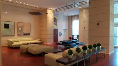 a living room with couches and tables in a building at Coconut Grove 10th Floor private unit Parking Included in Miami