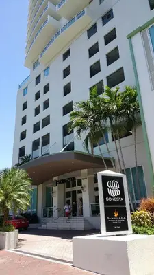 a building with a sign in front of it at Coconut Grove 10th Floor private unit Parking Included in Miami
