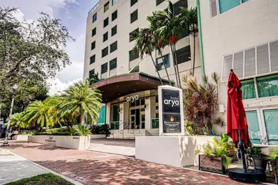 a building with a red umbrella in front of it at Coconut Grove 10th Floor private unit Parking Included in Miami