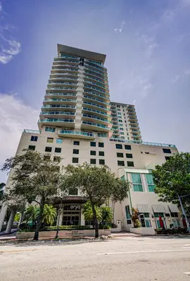 a tall building with trees in front of it at Coconut Grove 10th Floor private unit Parking Included in Miami