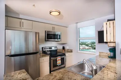 a kitchen with a stainless steel refrigerator and a sink at Coconut Grove Gorgeous Bay View 1 bedroom Condo Includes Parking in Miami