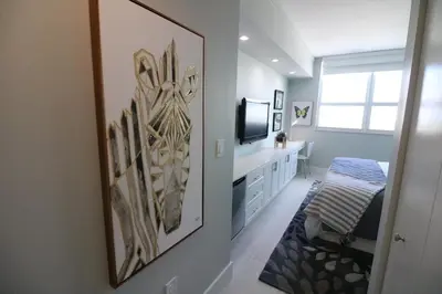 a bedroom with a painting on the wall and a television at Connecting Rooms-Coconut Grove 21st Floor Parking Included in Miami