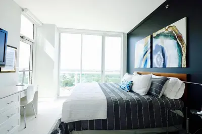 a bedroom with a bed and a large window at Coconut Grove 21st Floor Private Studio-Parking & WIFI included in Miami