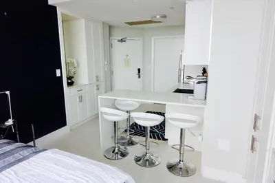 a kitchen with a counter and stools in a room at Coconut Grove 21st Floor Private Studio-Parking & WIFI included in Miami