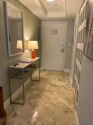 a room with a desk with a mirror and a door at Cozy 1 bedroom unit located in a Condo Hotel in the heart of Coconut Grove Free Parking in Miami