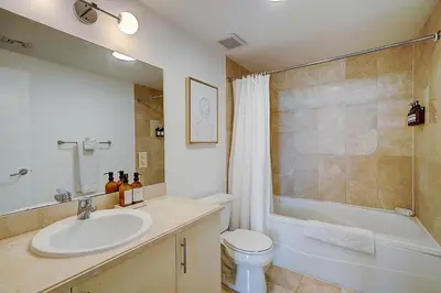 a bathroom with a sink and a toilet and a shower at Coconut Grove 1 bedroom condo parking included in Miami